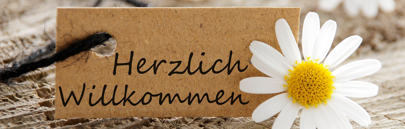 Schriftzug "Herzlich Willkommen" mit Blume