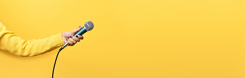 Mikrophon vor gelbem Hintergrund